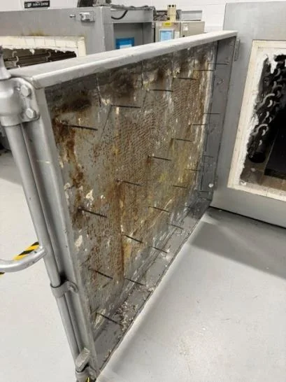 Oven door stripped back to bare steel, ready for new anchor pins