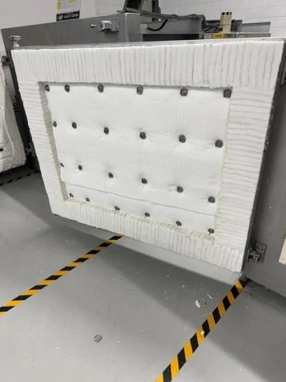 Finished oven door with overlapping Superwool face secured in place